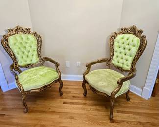 ornate armchairs feature a distinct Rococo and Baroque revival style with bright green velvet upholstery