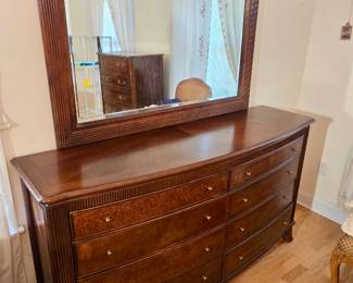 traditional wood triple dresser with a bowed front and burl wood drawer faces