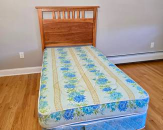 twin-size bed featuring a classic wooden slatted headboard