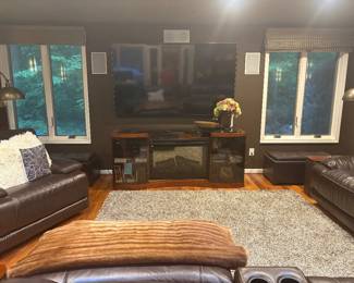 Entertainment center w electric heater/fireplace, large screen TV w wall mount (82" and another 72"), leather ottomans, floor lamps, blankets, pillows