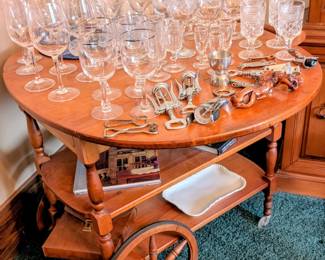 Bar cart with lots of vintage bar glasses