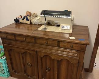 Singer sewing machine table. Doors open up for storage and pedal. Machine goes into the table for a flat surface.
