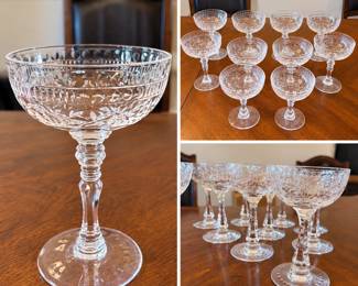 Elegant collection of vintage clear crystal champagne coupes featuring finely etched and cut decorative patterns. The grouping includes floral and foliate motifs, geometric border details, broad shallow coupe bowls, and decorative stems. The classic coupe form makes these especially attractive for champagne, cocktails, dessert service, or display in a vintage barware collection. The collection includes more than one coordinating pattern/style and is offered together as shown. Maker and patterns have not been confirmed. Pre-owned vintage condition with wear consistent with age and use; please review photographs for exact quantity, pattern variations and condition.