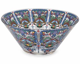 Striking decorative clear glass bowl featuring an elaborate stained glass–inspired design in muted shades of blue, lavender, green, rose, gold and black. The interior is centered by a large symmetrical floral medallion surrounded by repeating stylized floral, foliate and geometric panels extending around the sides and rim. Gold-tone accents add subtle highlights throughout the pattern. The transparent glass construction allows the colorful decoration to be viewed from multiple angles, creating an especially attractive display piece. Presented in good pre-owned condition with light wear consistent with age and use; please review photographs carefully as they are considered part of the condition description. Maker not identified.