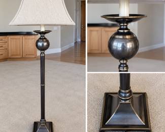 Elegant traditional floor lamp featuring a tall dark bronze-tone column accented with warm brass-tone trim, a substantial rounded urn-form body, and a stepped architectural square base. Topped with a large neutral textured fabric shade, giving the lamp a sophisticated neoclassical-inspired appearance suitable for a living room, library, office or bedroom. The combination of dark metal finishes and subtle gold-tone accents provides a versatile, upscale look. Pre-owned condition with expected light surface wear from normal use. Please review photographs for condition and details.