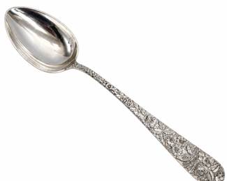 Beautiful S. Kirk & Son Inc. sterling silver serving spoon featuring the firm's highly recognizable all-over repoussé floral decoration, with deeply worked roses, blossoms, leaves and foliage extending along the handle. The reverse is clearly marked “S. Kirk & Son Inc. Sterling.” Approximately twelve inches long based on the photographed measurement. The spoon shows surface scratches, patina and signs of use consistent with age. An impressive example of American sterling silver hollowware/flatware craftsmanship and a desirable addition to a Kirk sterling, Baltimore repoussé, antique silver or serving collection. Please review all photographs for design details, markings, measurements and condition. Dimensions 12" long