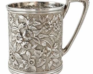 Antique Daniels sterling silver cup featuring elaborate raised repoussé floral decoration with roses, blossoms, leaves and scrolling foliage extending around the body. The richly textured floral design is complemented by a decorative angular handle and molded rim and base. Marked “DANIELS STERLING” on the underside. The cup is monogrammed on the side. Surface wear, scratches, tarnish and other signs of age and use are present; please review photographs carefully for condition, markings and details. An impressive piece of antique sterling silver hollowware with exceptional decorative detail, ideal for collectors of American silver, ornate tableware and floral repoussé silver.