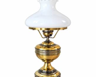 Elegant vintage brass hurricane-style table lamp featuring a polished brass body with rounded reservoir-form center, decorative pierced metal banding and a substantial stepped pedestal base. The lamp is topped with a large glossy white milk glass shade with a ruffled upper edge and clear glass chimney, creating the classic appearance of an antique oil lamp. Brass surfaces display warm aged character and patina consistent with previous use. An attractive statement lamp well suited for traditional, Colonial, Victorian or vintage-inspired interiors. Pre-owned vintage condition with expected surface wear and oxidation associated with age and use. Please review photographs carefully for condition, glass components and decorative details.