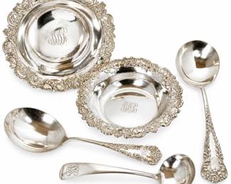 Beautiful collection of antique sterling silver small serving bowls with coordinating ladles and serving spoons. The bowls feature elaborate pierced and repoussé-style borders with scrolling floral and shell decoration and elegant engraved monograms. Accompanying sterling silver ladles and spoons display a variety of ornate period patterns, including richly decorated floral and scroll handles. A wonderful grouping of fine estate silver suitable for serving condiments, sauces, preserves and other table accompaniments, or for addition to an antique sterling silver collection. Pieces show surface scratching, patina and age-appropriate wear consistent with use. Makers and individual patterns have not been confirmed; please refer to photographs and visible hallmarks for additional identification. Sold together as one collection.