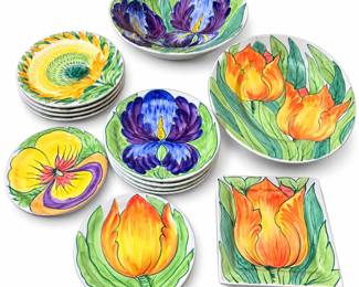 Vibrant coordinating ceramic dinnerware and serving collection featuring bold hand-painted-style botanical designs in purple, blue, orange, yellow and green. The collection includes assorted plates and bowls decorated with iris, tulip, pansy and sunflower-inspired floral motifs, along with larger coordinating serving pieces and a square floral plate. The oversized serving pieces create an especially striking table presentation, while the varied floral patterns coordinate through their shared palette and expressive botanical design. Pieces show glossy glazed surfaces and substantial ceramic construction. Offered as one collection as photographed. Pre-owned condition with expected signs of use including possible light utensil marks, surface wear and minor imperfections; please review photographs carefully for exact contents, patterns and condition. Maker and pattern have not been independently confirmed.