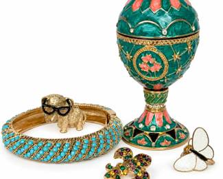 Colorful vintage-style jewelry and decorative collection featuring an ornate Fabergé-inspired hinged egg trinket box with rich green marbled enamel, coral-pink floral accents, gold-tone detailing and clear rhinestone embellishments on a pedestal base. Collection also includes a wide gold-tone hinged bangle bracelet accented with rows of turquoise-colored stones, a whimsical textured gold-tone elephant pin/brooch wearing black eyeglasses, a white enamel butterfly pin, and a gold-tone fleur-de-lis pin embellished with multicolored rhinestones. An eye-catching mixed collection combining enamel, rhinestones, figural motifs and jewel-tone colors. Metal content, gemstones/stones, makers and age have not been independently verified unless otherwise noted. Please review all photographs for design, markings, condition and included pieces; photographs are considered part of the description.