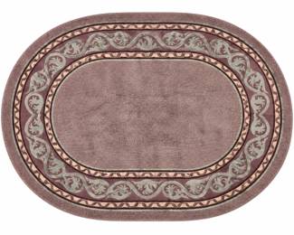 Large oval area rug featuring a rich purple field surrounded by a decorative scrolling foliate border in coordinating burgundy, sage green, cream and dark accent tones. The layered border design gives the rug a traditional, elegant appearance while the oval shape makes it especially well suited for a dining area, bedroom, sitting room or large entry. Soft pile construction with bound edges. Pre-owned condition with expected signs of use and wear; please review photographs for overall condition and color.