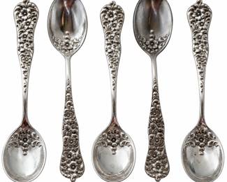 Beautiful set of five antique sterling silver demitasse spoons featuring elaborate raised floral and scrolling decoration extending across the handles and into the bowls. The reverse bears a script monogram, and the spoons are marked “STERLING” along with additional maker/patent marks. Approximately four inches in length based on the photographed ruler. These highly decorative small spoons are ideal for espresso, coffee service, collectors of antique sterling silver flatware, or an elegant tabletop collection. Vintage condition with surface wear, scratches, patina and signs of use consistent with age. Please review all photographs for markings, measurements, condition and details; photographs are considered part of the description.