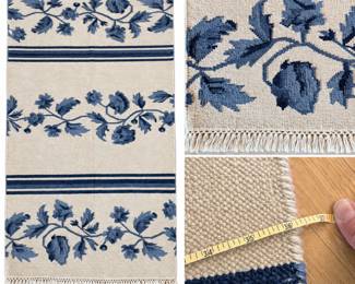 Blue & Ivory Floral Accent Rug with Fringe – 36" x 60"Decorative 36" x 60" rectangular accent rug featuring a warm ivory ground with repeating floral vine motifs in shades of navy, slate and blue-gray. Horizontal navy stripe bands divide the floral design, while knotted fringe finishes both ends for a relaxed traditional look. The neutral palette with classic blue botanical decoration works well in an entryway, kitchen, bedroom, hallway or sitting area. Measures approximately 36" x 60". Pre-owned condition with signs of previous use and minor surface wear; please review photographs carefully for condition, color and construction details.