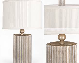 Sophisticated contemporary table lamp featuring a substantial vertically fluted column-form body with a textured silver-gilt metallic finish and warm champagne-gold undertones. The architectural base is accented by a rounded decorative neck and rectangular metallic finial, and is topped with a coordinating ivory ribbed drum shade. The combination of classical fluting and a streamlined silhouette gives the lamp a versatile transitional to contemporary appearance. Pre-owned condition with light surface wear consistent with normal use. Please review photographs for condition and details.