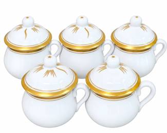 Charming set of five matching porcelain lidded cups made in Portugal and marked “PIA Portugal / Made in Portugal” on the underside. Each features a classic white porcelain body with curved handle, fitted domed lid, and elegant gold gilt banding and decorative accents. Cups measure approximately 2½ inches high to the rim and approximately 3½ inches high with lids in place. Set shows age-appropriate wear, including some loss and wear to the gold decoration and minor surface marks; please review photographs for individual condition. An attractive vintage Portuguese porcelain set for serving, display, or collection.