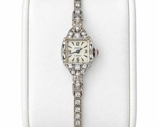 Elegant vintage Croton ladies’ manual-wind wristwatch featuring a petite rectangular silver-tone dial marked “CROTON” and “17 JEWELS,” surrounded by an ornate diamond-set case and matching articulated bracelet. The bracelet is set throughout with square and round-cut diamonds in detailed vintage settings, with additional diamond accents framing the watch case. Clasp is marked 4K. Case back is engraved “BBA 6-10-58,” providing a likely 1958 presentation date. Safety chain and fold-over clasp. A beautiful example of mid-century fine jewelry watchmaking with strong Art Deco-inspired styling. Watch winds, is currently running, and has been observed keeping time. Accuracy and long-term mechanical performance have not been professionally tested. Diamonds and gold content should be considered based on markings and visual inspection unless otherwise independently tested. Please review photographs for condition, markings, and details.