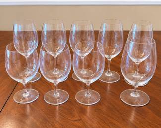 Collection of nine quality crystal water glasses by Riedel and Schott Zwiesel, two respected European makers of premium stemware. Featuring classic clear crystal construction with generously proportioned bowls, short elegant stems, and round footed bases. The understated designs coordinate beautifully with a variety of wine and tableware patterns, making this an excellent addition to a formal or everyday table setting. Includes a mixture of Riedel and Schott Zwiesel glasses as shown. Pre-owned condition with light signs of normal use and storage; please review photographs for individual condition.