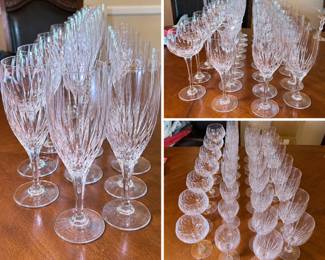 Large collection of coordinating clear crystal stemware featuring elegant elongated vertical and fan-style cuts that create a brilliant light-catching presentation. The collection includes multiple stemware forms and sizes, including tall wine/water goblets, champagne flutes and smaller wine or cordial-style glasses. Graceful tapered bowls, slender stems and circular feet give the collection a sophisticated formal-table appearance. An impressive grouping for entertaining, holiday dining, weddings or expanding an existing crystal service. Maker and pattern have not been confirmed. Collection is offered as shown; please review photographs for exact quantities, sizes, condition and individual variations. Pre-owned condition with light wear consistent with age and use.