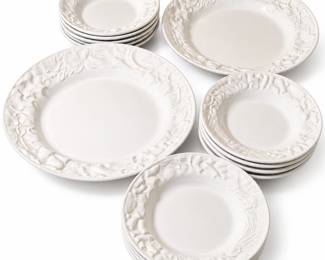 Elegant Williams Sonoma white ceramic pasta and salad bowl collection featuring richly embossed raised decoration around the rims with fruit, foliage and textural motifs. Made in Portugal and marked Williams-Sonoma on the underside; pieces are marked dishwasher and microwave safe. This fourteen-piece collection includes twelve individual place bowls plus two larger serving bowls, creating a versatile set for pasta, salads, soups and family-style serving. The classic all-white glazed finish highlights the dimensional relief decoration and coordinates easily with a variety of table settings. Pre-owned condition with expected light signs of use; please review photographs for individual condition and details.