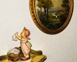 One of several Hummels on brass shelf