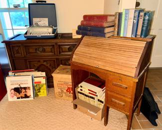 Child’s antique roll-top desk, Records, Children’s Encyclopedia Set, RCA Victor Victrola Phonograph, Magnavox Astro-Sonic stereo and phonograph console, Royal Safari Portable Typewriter, Vintage books