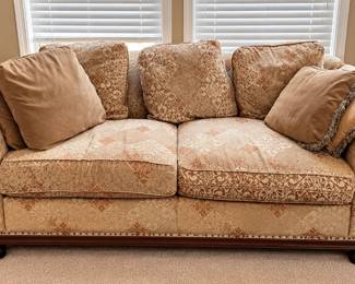 Traditional upholstered sofa with wood trim and accent pillows – $300