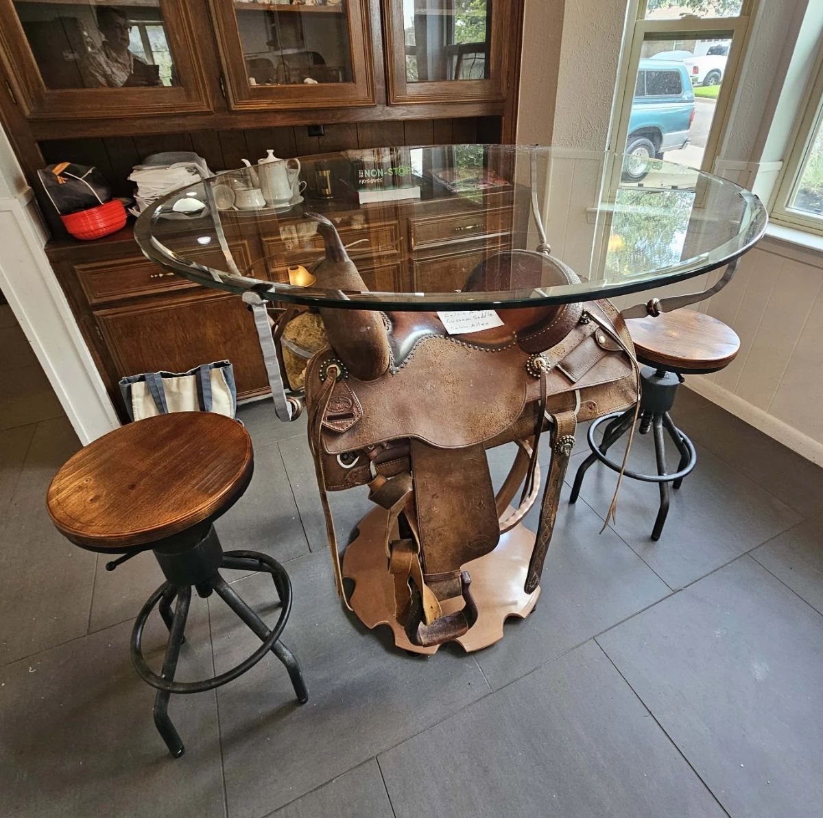 This table was designed to display this Calvin Allen saddle and includes two seats.