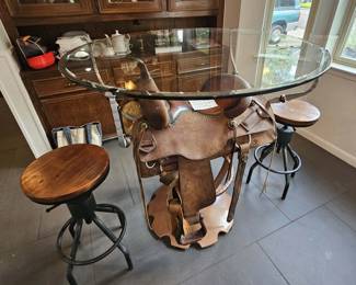 This table was designed to display this Calvin Allen saddle and includes two seats.