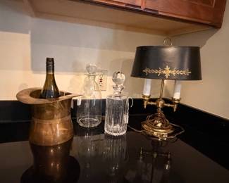 Antique brass top hat ice bucket, Bouilotte lamps throughout the home, crystal decanturs