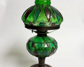Antique European green glass oil lamp featuring a dual-section molded body and a metal base.
