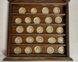 Wooden display rack holding the Franklin Mint Antique English Silver Miniature Plate Collection from 1981.