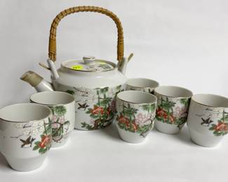 Vintage mid-century Japanese porcelain tea set featuring a woven bamboo swing handle and a hand-painted floral, bamboo, and bird design with gold trim