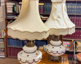 Vintage Victorian-style table lamps featuring a white ceramic and brass-accented base paired with ornate lace-trimmed bell lampshades.