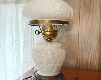 Vintage Fenton "Gone with the Wind" style lamp that features the classic embossed white milk glass poppy pattern and an ornate metal base. 