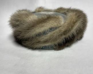 Vintage-style pillbox hat features a soft, beautifully coiled grey and taupe fur texture with a classic mid-century silhouette.