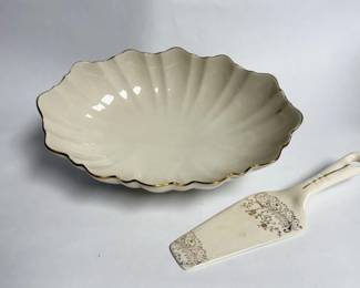 Vintage ivory porcelain Lenox Symphony Centerpiece Bowl featuring a distinctive 24K gold-trimmed scalloped rim with a vintage ceramic pie and cake server with a gold leaf or floral scroll design.
