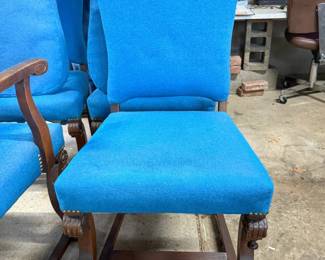 Antique-style high-back side chair with bright blue upholstery and carved wooden scroll feet.