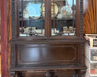 Antique carved wood display cabinet and secretary desk combination.