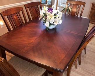 Dining room table with chairs and extra leaves