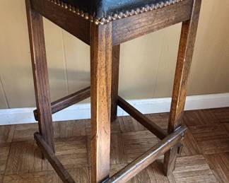 Rustic Wood Bar Stool with Nailhead Trim and Dark Upholstery second image