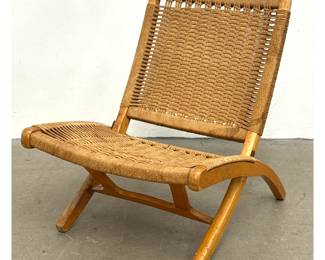 Lot 530 Mid Century Modern folding lounge chair in light hardwood and hand woven cord. Wegner style. 