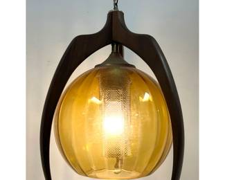 Lot 281 Mid Century Modern Walnut and Amber Glass Swag Pendant Light. Ribbed Amber Glass Ball Shade with Per