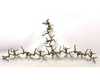Lot 623 Falling People wall Sculpture. Gold finished cast aluminum. 