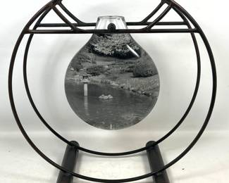 Lot 546 Art Glass and Iron Table Sculpture. Thick Glass bottle form center has photograph film inside and O