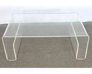 Lot 498 Modernist Acrylic Waterfall Coffee Table. Storage end pockets. Clear acrylic construction.