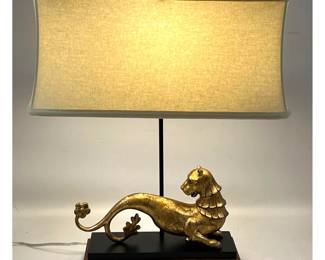 Lot 324 JOHN RICHARD Gilt Stylized Lion Table Lamp. Black and Gilt Base. Cream Fabric Corseted Shade.