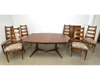 Lot 191 MidCentury Modern walnut dining room set featuring a boatshaped extension table with 2 leaves and 