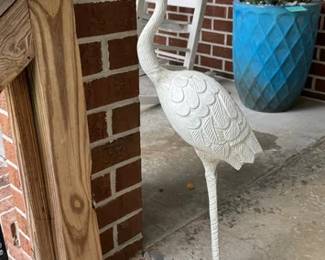 Metal crane statue, one of the several large ceramic planters available and white rocking chairs
