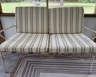 Wrought iron settee and cushions